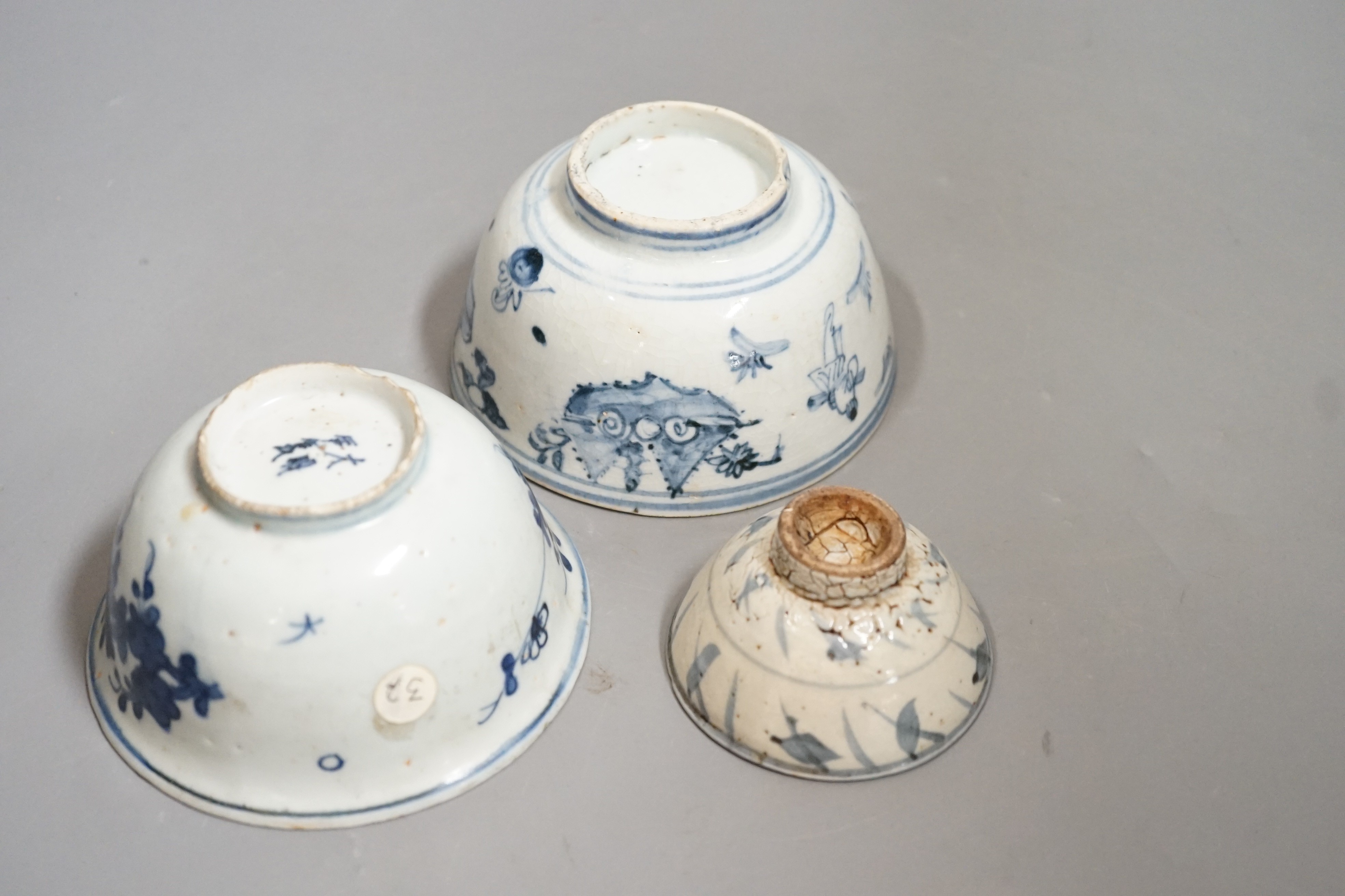 Three Chinese late Ming blue and white bowls, one painted with figures in a boat on horseback and in the landscape, the second with floral sprays, with ‘Made in the Great Ming dynasty’ mark and another bowl, largest 13.3